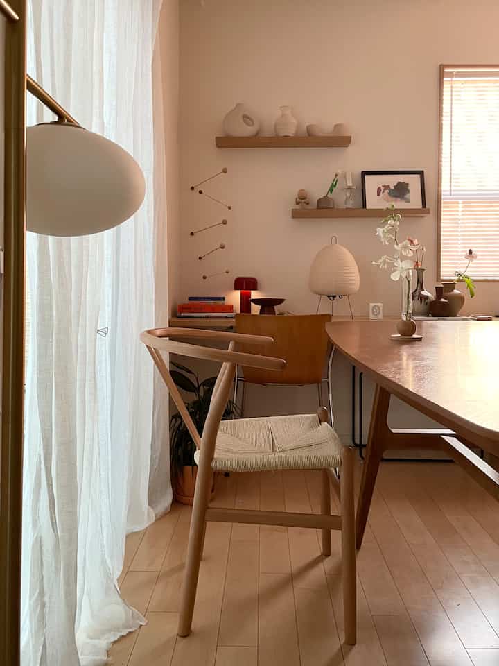 Beige and wood tone dining room featuring natural wooden furniture and warm lighting creating a cozy atmosphere
