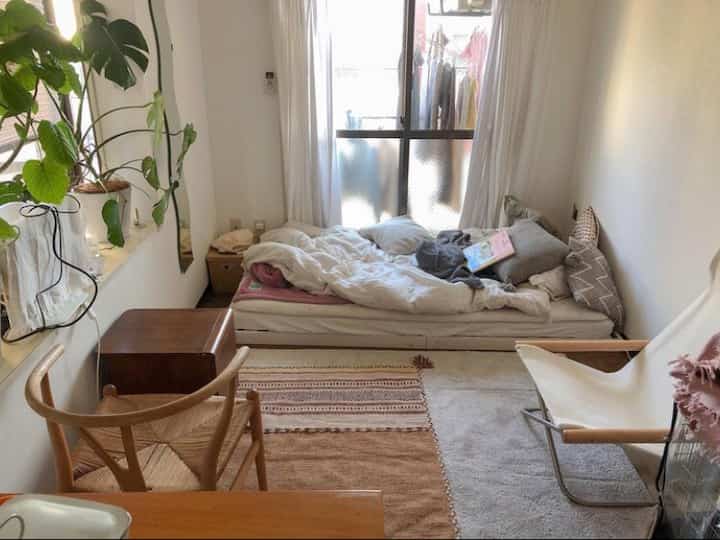 Natural toned 18㎡ studio apartment bedroom featuring wooden chairs and rugs with a cozy atmosphere