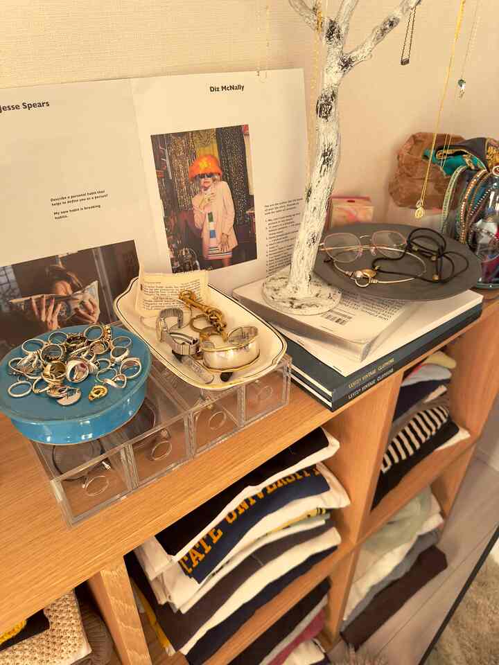 Cozy closet space with beige walls and natural wood tones featuring organized accessories and eyeglass cases