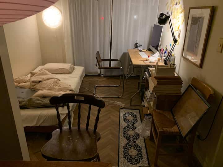 Warm natural-tone single household bedroom home office featuring wood tone furniture and curtains, creating a cozy atmosphere