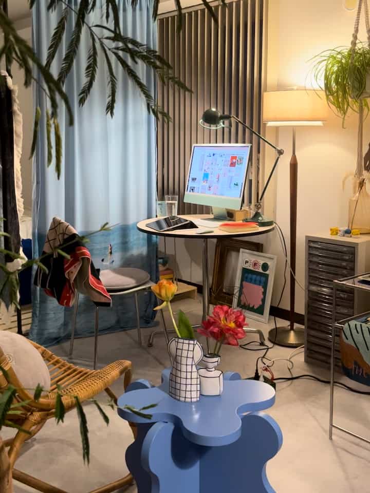 Blue and natural-tone workspace featuring mid-century modern furniture arranged in a cozy setting