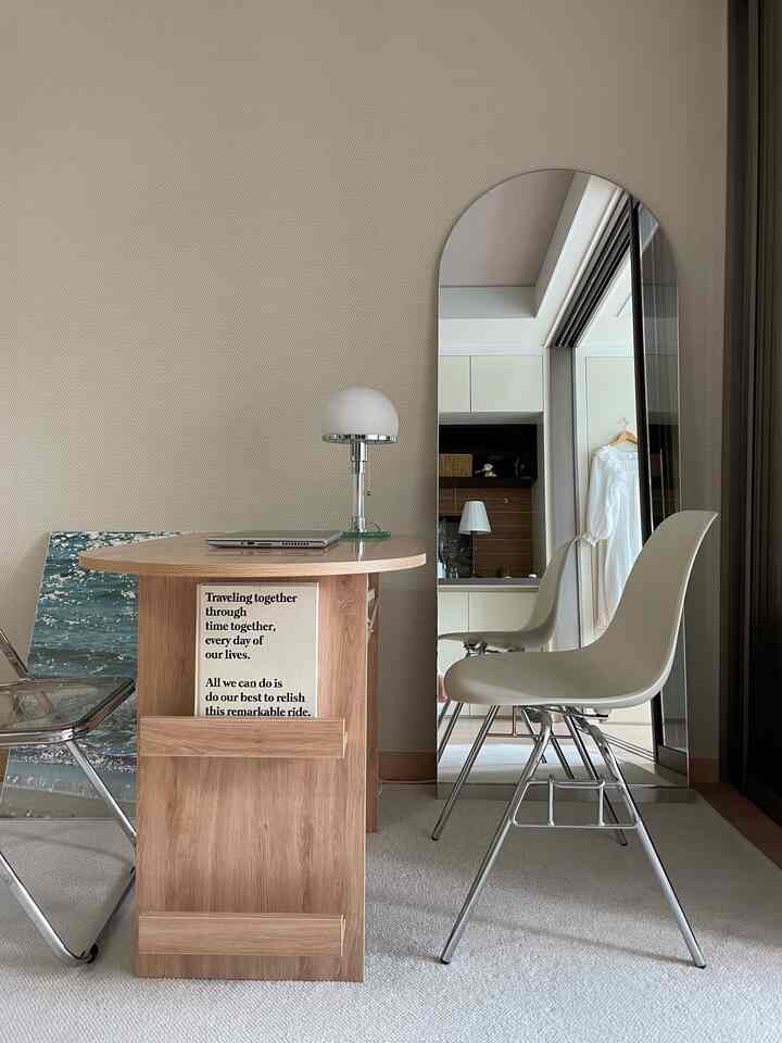 Natural wood and beige toned home office space featuring a simple desk and chair with a clean, minimalist atmosphere