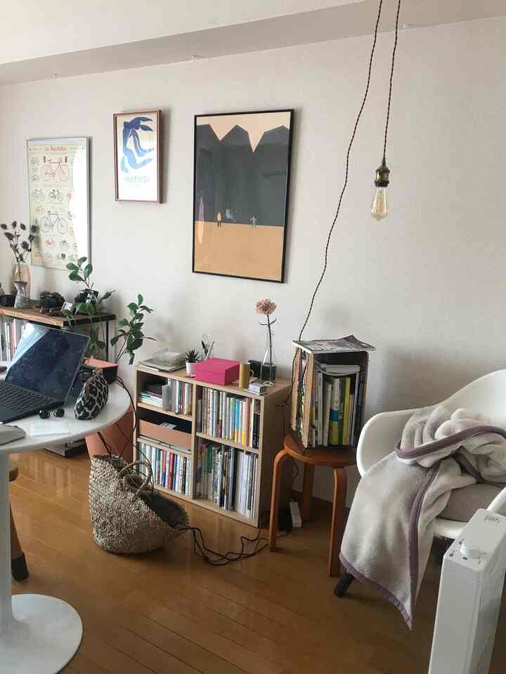 Natural wood-tone floor and simple furniture define a single household home office space