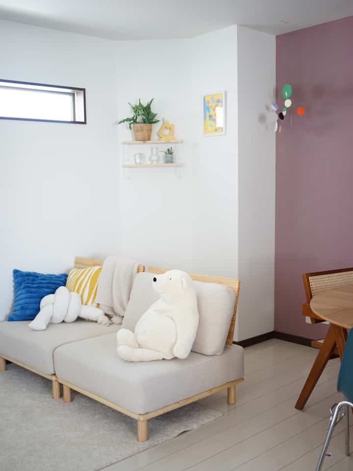 Modern living room with white walls and light brown furniture creating a clean, cozy atmosphere