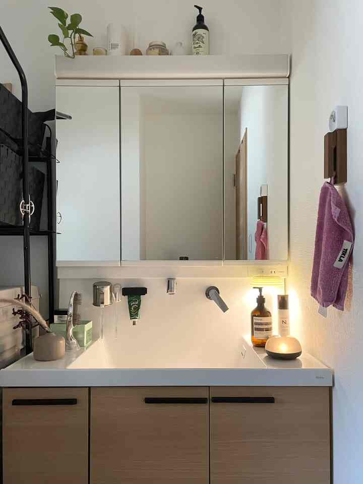 Natural wood tone and white bathroom sink area with clean and simple arrangement