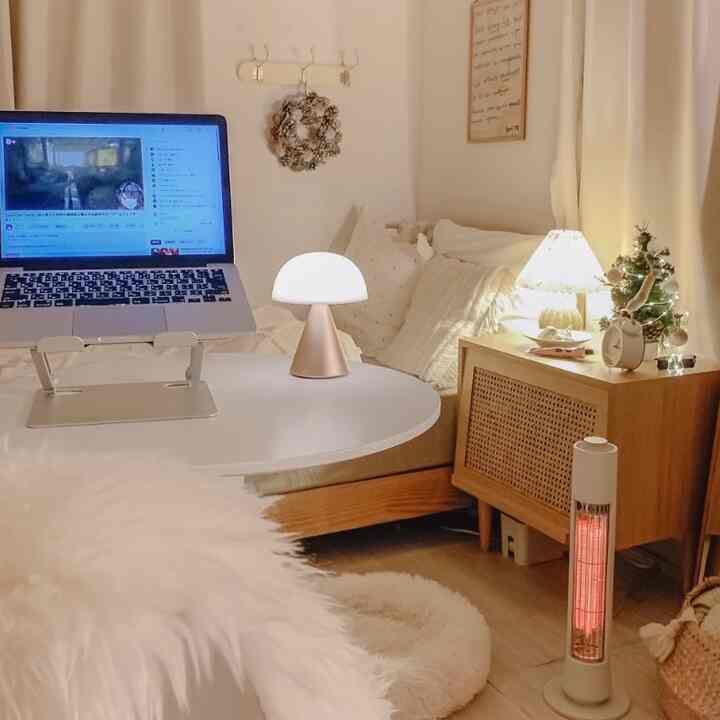 White and brown compact bedroom featuring table lamps and laptop in a cozy home office setup
