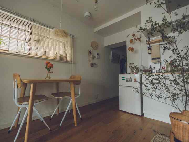 A cozy small dining room with natural wood tones featuring a wooden dining table and chairs, creating a calm and inviting atmosphere