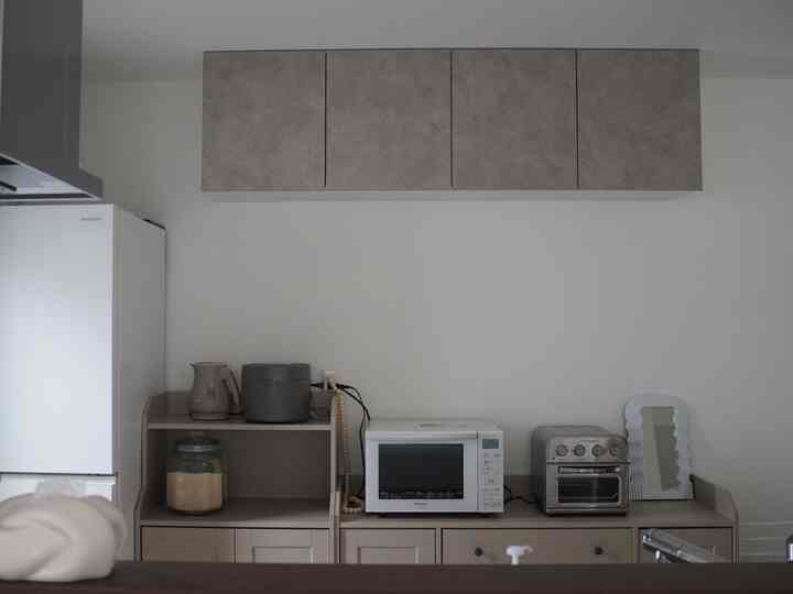 Gray and white toned kitchen featuring IKEA cabinets and microwave with a clean, minimalist look
