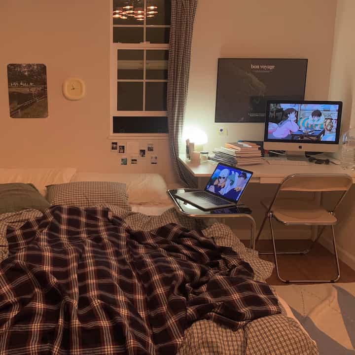 White and brown toned bedroom featuring bed and desk in a cozy compact room setting