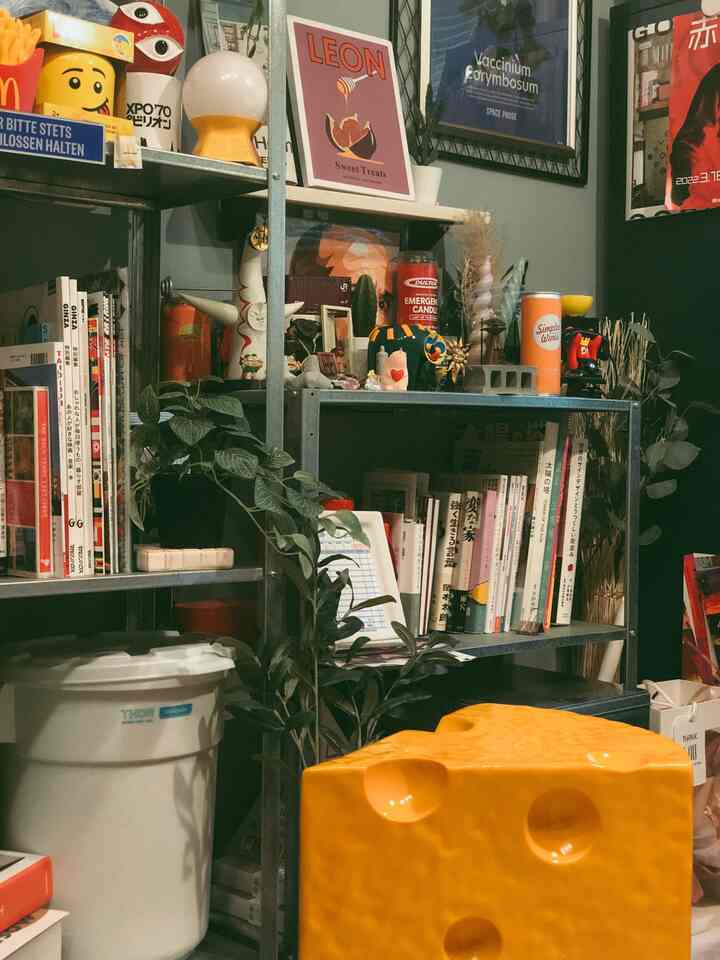 Yellow and white tones highlight shelves and objets in a cozy storage space for two-person household