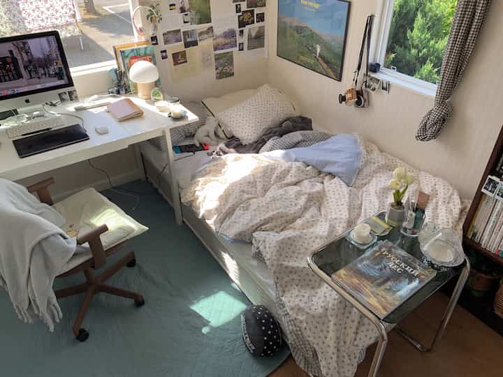 Soft ivory and blue toned small compact single household bedroom with home office setup