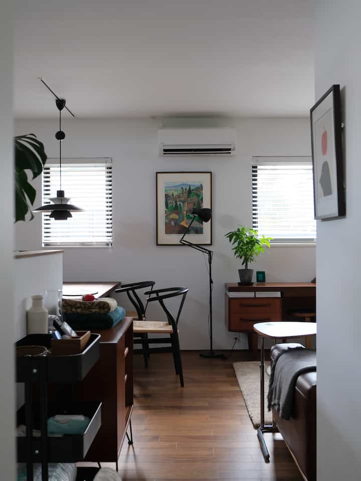 White-walled and brown wood-floored Nordic style two-person household living room and kitchen space