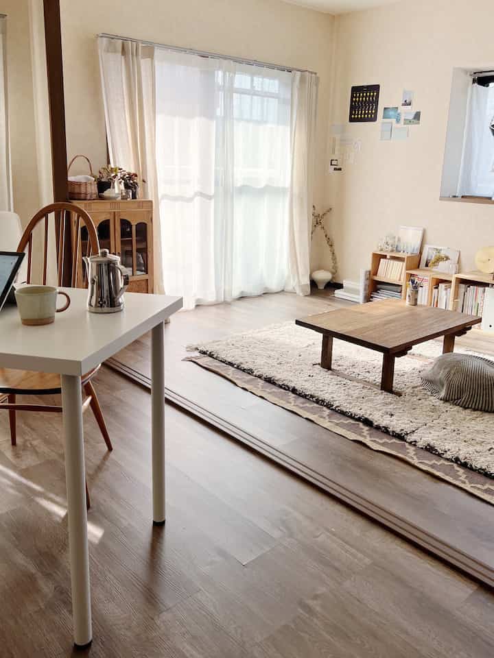 Bright natural modern living room with white and wood tones, featuring open layout and spacious atmosphere