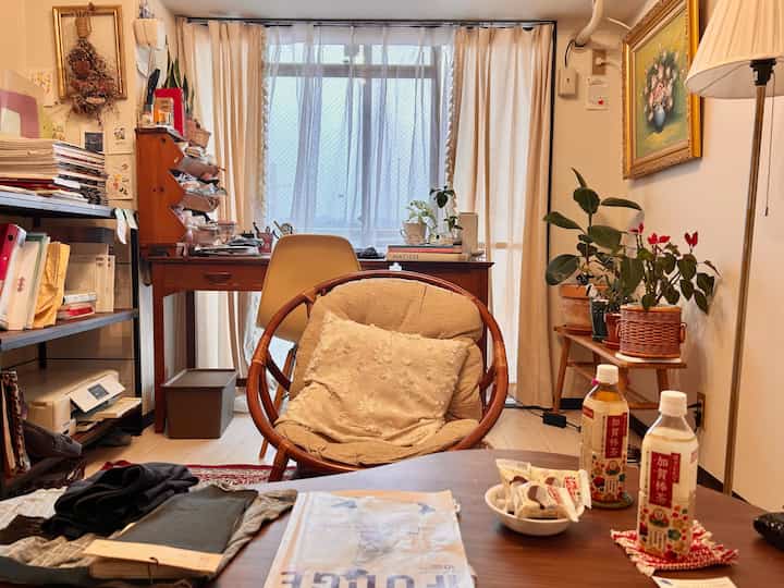 Beige-toned living room featuring a round chair and coffee table with a warm and cozy atmosphere
