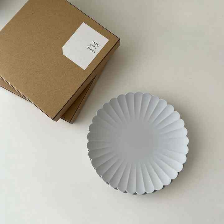 Clean image with 1616 Arita Japan package and TY Palaces Plate on a white-toned minimalist table surface