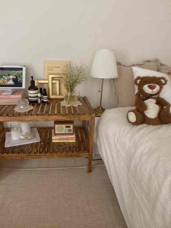 Beige and brown toned bedroom featuring a wooden side table and bear-shaped hot water bottle creating a cozy atmosphere
