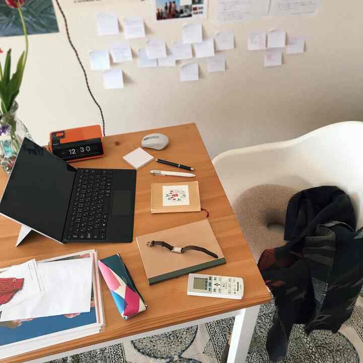 A natural-toned simple layout featuring a desk and armchair set for remote work