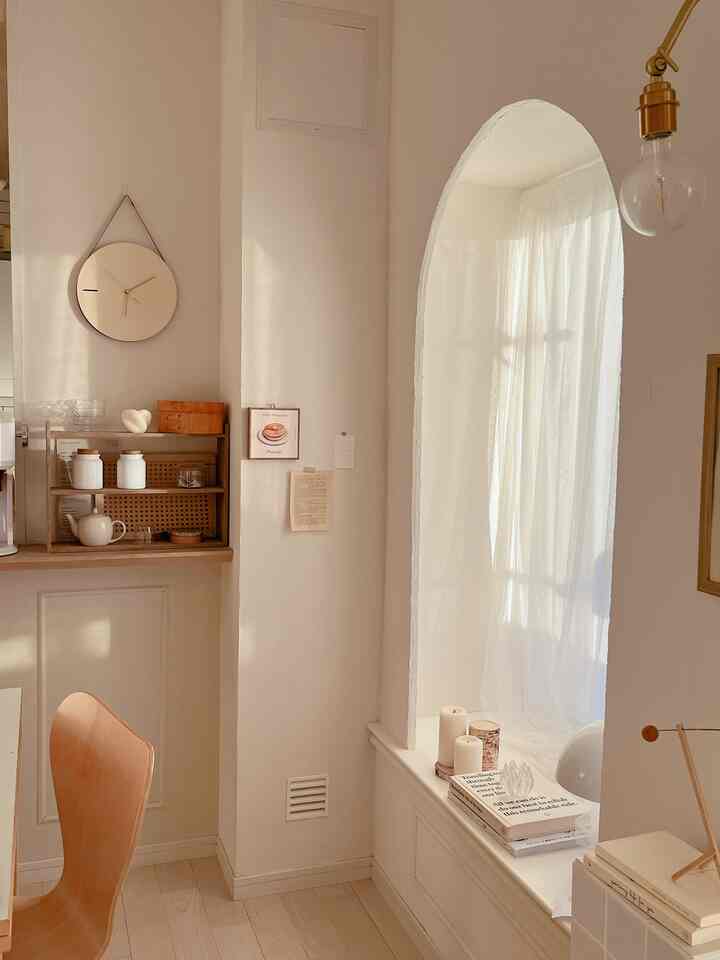 A warm wood tone and beige dining room featuring a wooden dining chair and window bench creating a cozy atmosphere