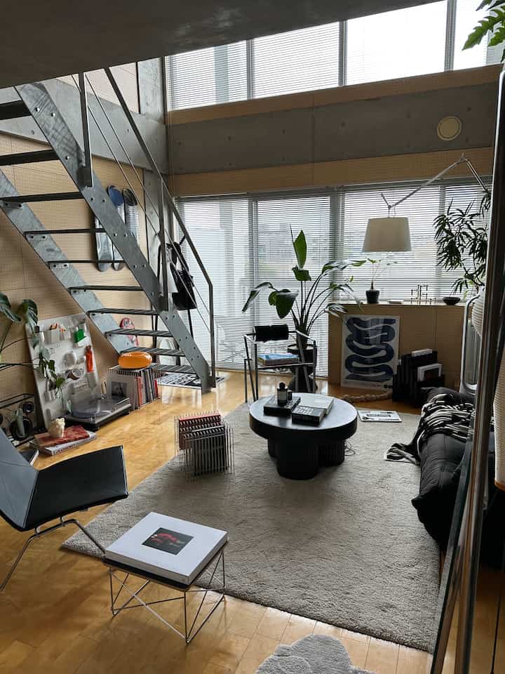 Natural color and modern style single household living room featuring black furniture and plants in a compact space