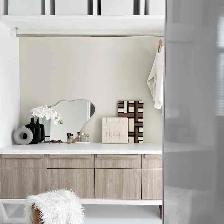 Natural color and white toned storage cabinet in a simple modern bedroom space