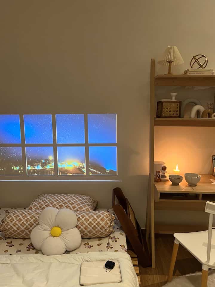 White and wood-tone 6-tatami bedroom featuring a modern desk and cushions creating a cozy remote work space
