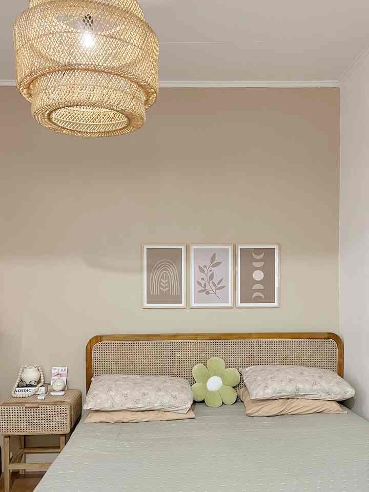 Light brown and beige toned bedroom featuring rattan furniture and pendant lamp, creating a minimal and warm atmosphere