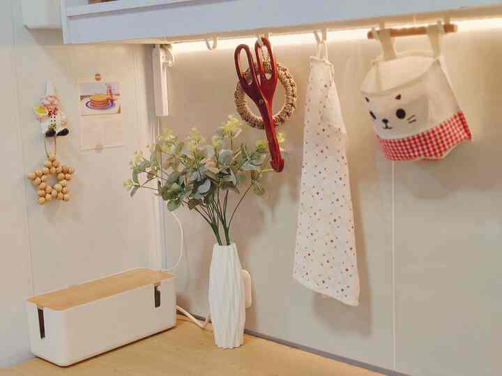 White and natural tone kitchen corner featuring storage ideas with neat hanging accessories