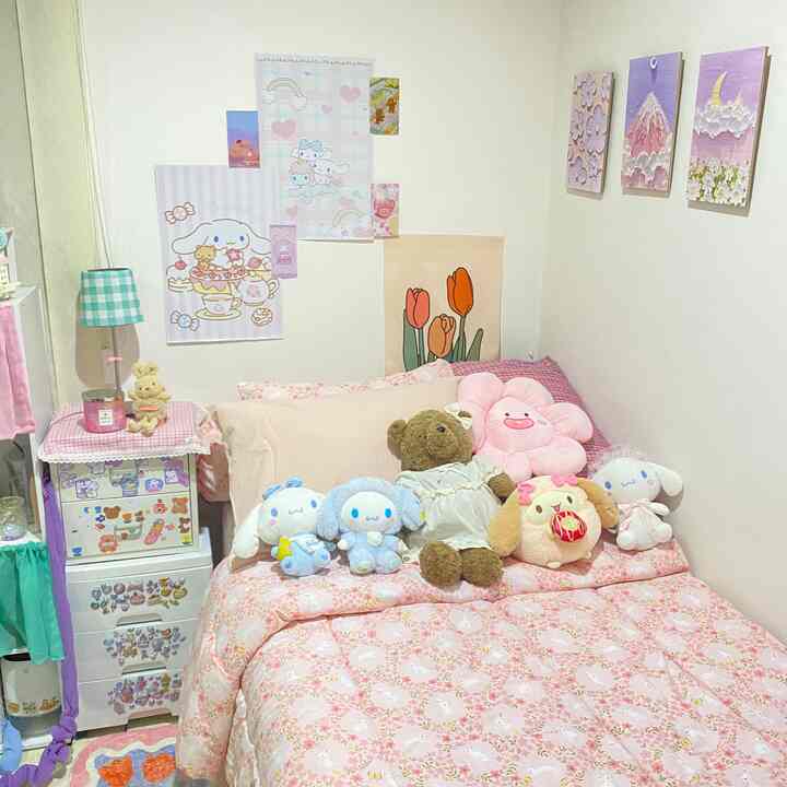Pastel pink toned bedroom featuring cute stuffed toys and floral bedding with a cozy atmosphere