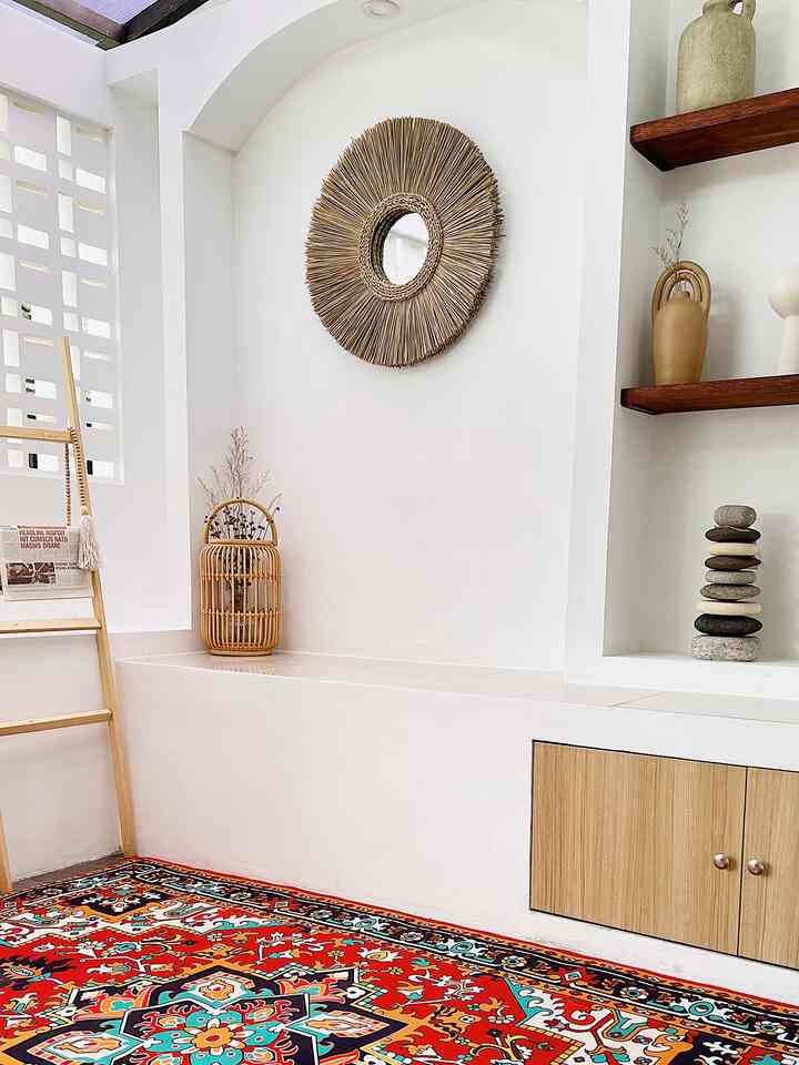 Bright white walls and wood-tone shelves featuring a vibrant Bohemian style carpet in a natural aesthetic living space