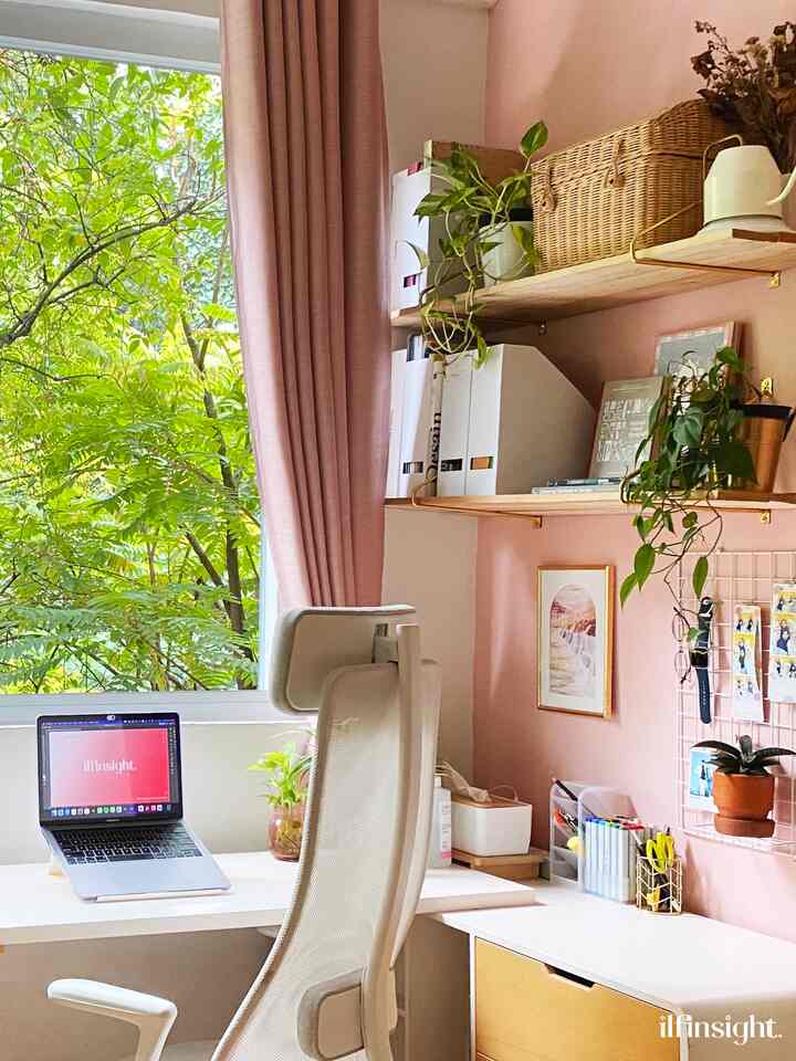 Pink-toned natural style bedroom home office with balcony view, featuring white desk, office chair, and plants creating a cozy atmosphere