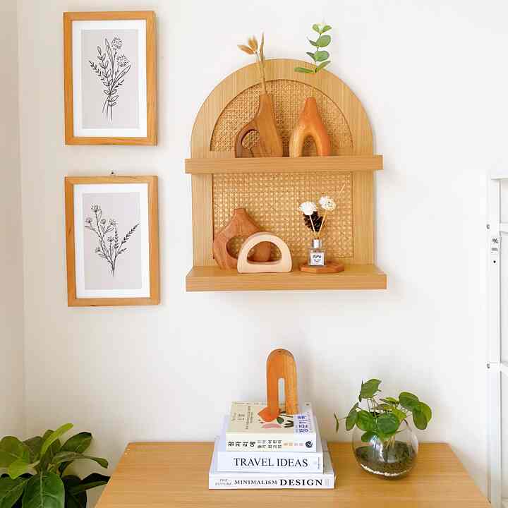 Minimal Korean-style entrance with white walls and wood tones, featuring wooden shelves, vases, plants, and a warm natural atmosphere