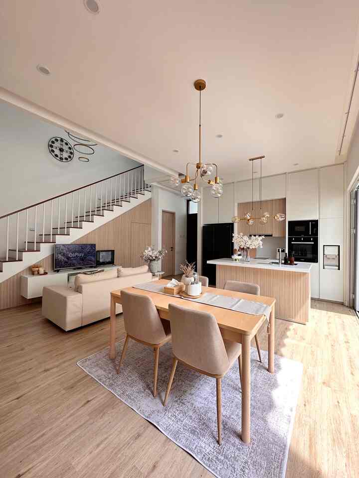 Warm wood tone and beige Japandi style living and dining room featuring modern elements and natural light