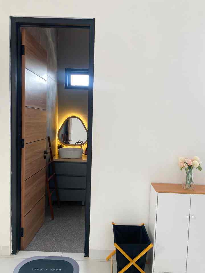 White and wood tone industrial style bathroom featuring sink, unique mirror with backlighting, and clean minimalist setup