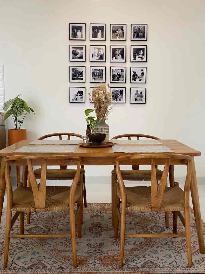 Wood tone and white dining room featuring mid-century style chairs with a cozy atmosphere