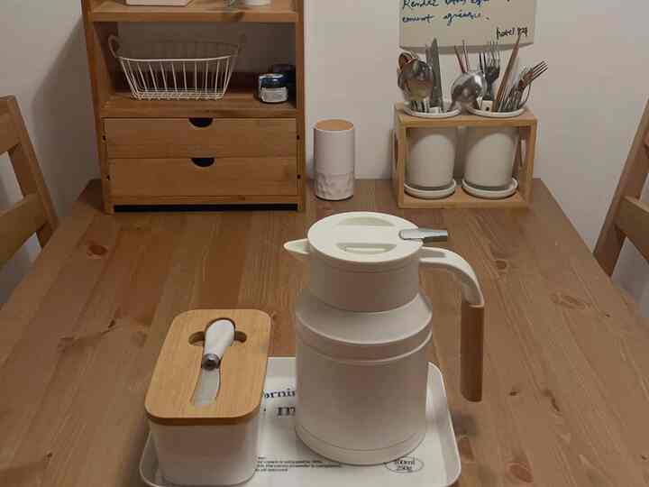 Natural wood tone and white items arranged in a small cozy dining room dining table space