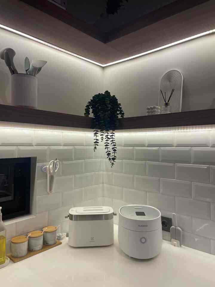 White monotone kitchen featuring clean lighting and storage ideas in a modern setting