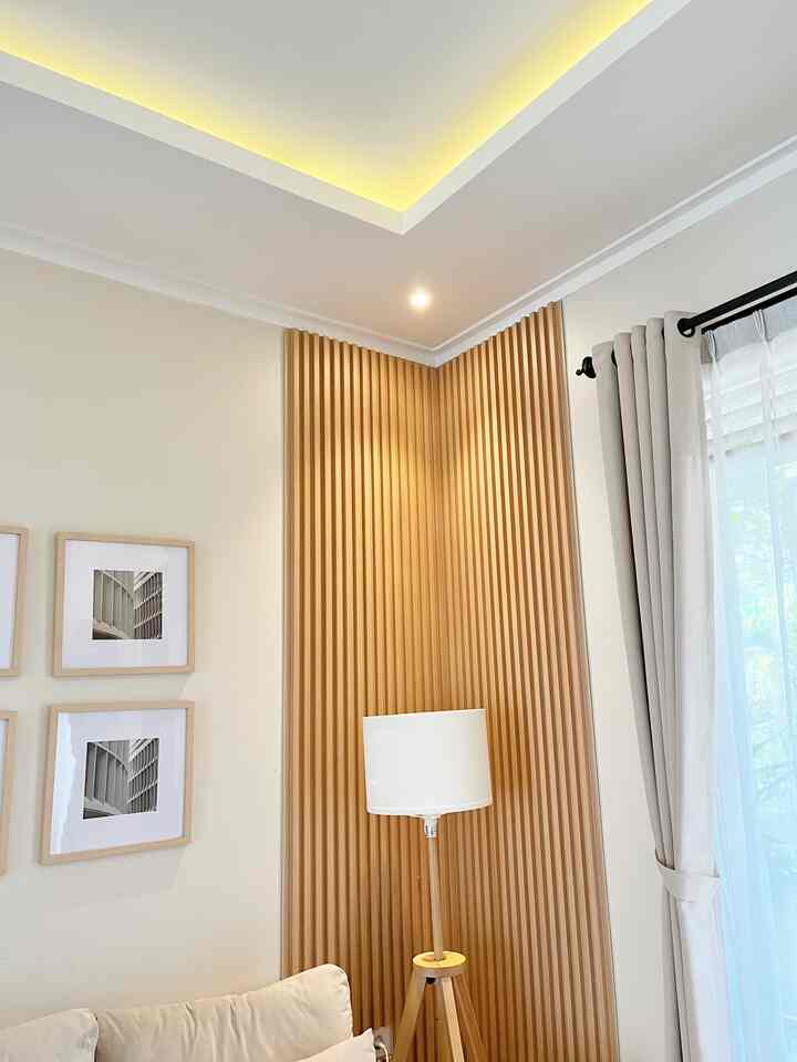 Ivory-toned living room featuring wood-tone 3D wall panels and a LAUTERS floor lamp in a modern Japandi style interior