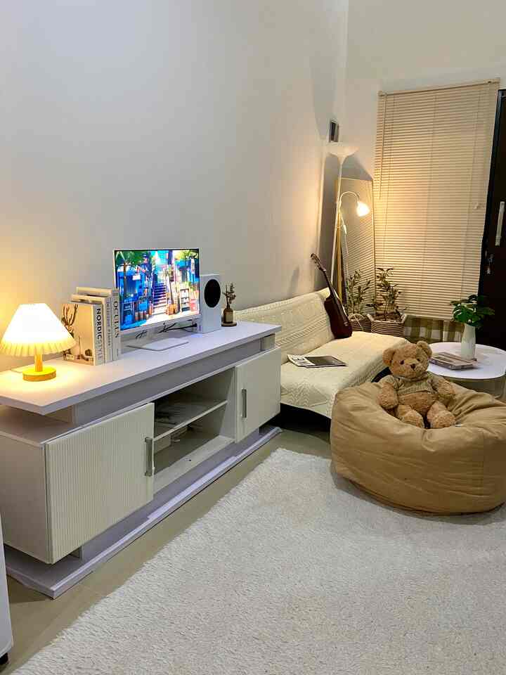 The living room and relaxing room with the family is the place that I think is my favorite and most comfortable. Apart from that, the appearance during the day or night feels aesthetic with a combination of furniture and other decorative items.

I made the atmosphere in this room cozy warm so that at night when you relax you feel warm and comfortable. Using lights as displays also adds a minimalist impression to the room.

The sofa combined with a standing lamp and standing mirror is an important point in this room's aesthetic appearance, plus the olive tree makes it look quite beautiful even though it's not a real flower.

I like this room because apart from being a place to relax and visit, this place can be used for me to learn guitar, read books and do other fun activities. Close to windows and entrances makes the room cooler and fresher.

#aestheticroom #aesthetichomedecor #homestyling #livingroom #cozyplace #rumahmungil