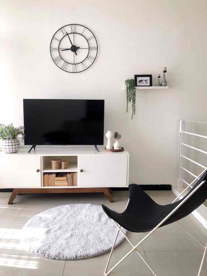 Monotone white and black living room featuring TV stand and butterfly chair with simple minimalist atmosphere