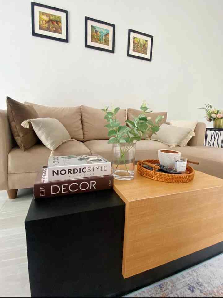 Natural living room in soft beige and wood tones featuring a beige sofa, wooden coffee table, and plant with a simple atmosphere