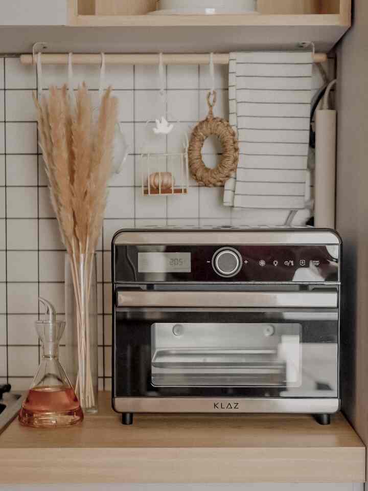 Natural toned kitchen corner featuring a wood countertop with a multi-function oven air fryer and natural decor elements