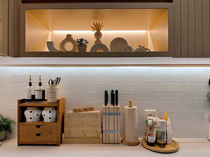 Beige and white toned small kitchen featuring simple storage ideas and clean Japandi-inspired design