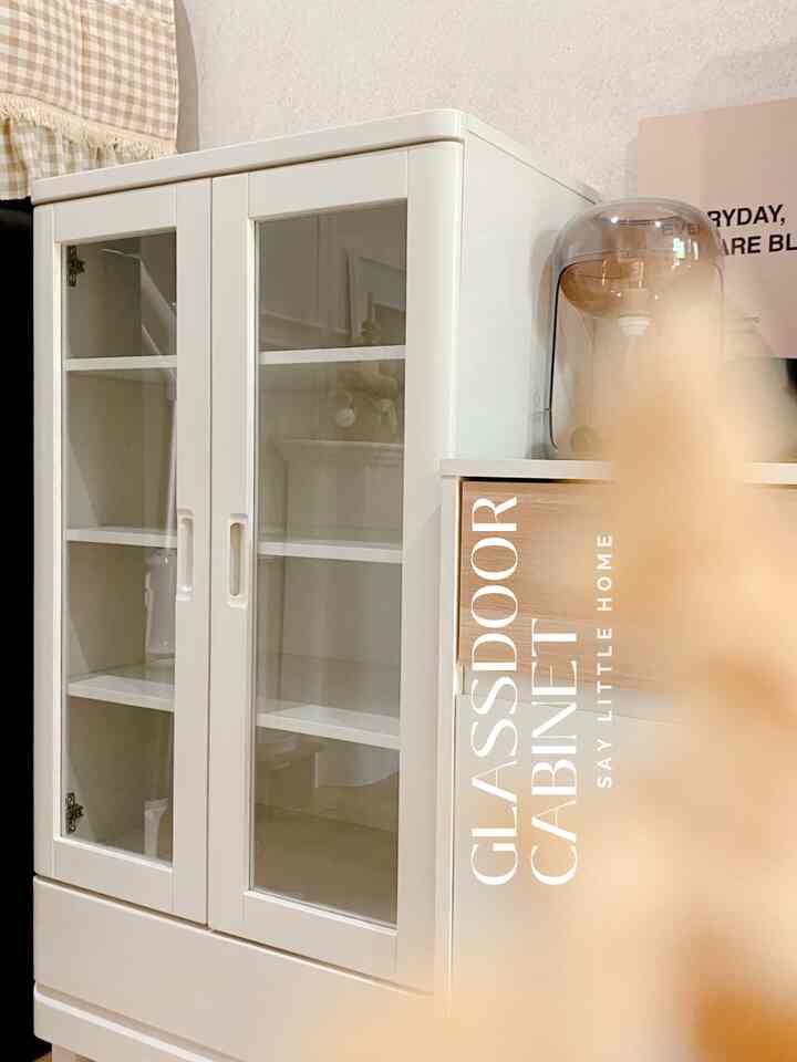 A cozy K-style interior corner with white glass cabinet and brown table lamp creating a natural tone