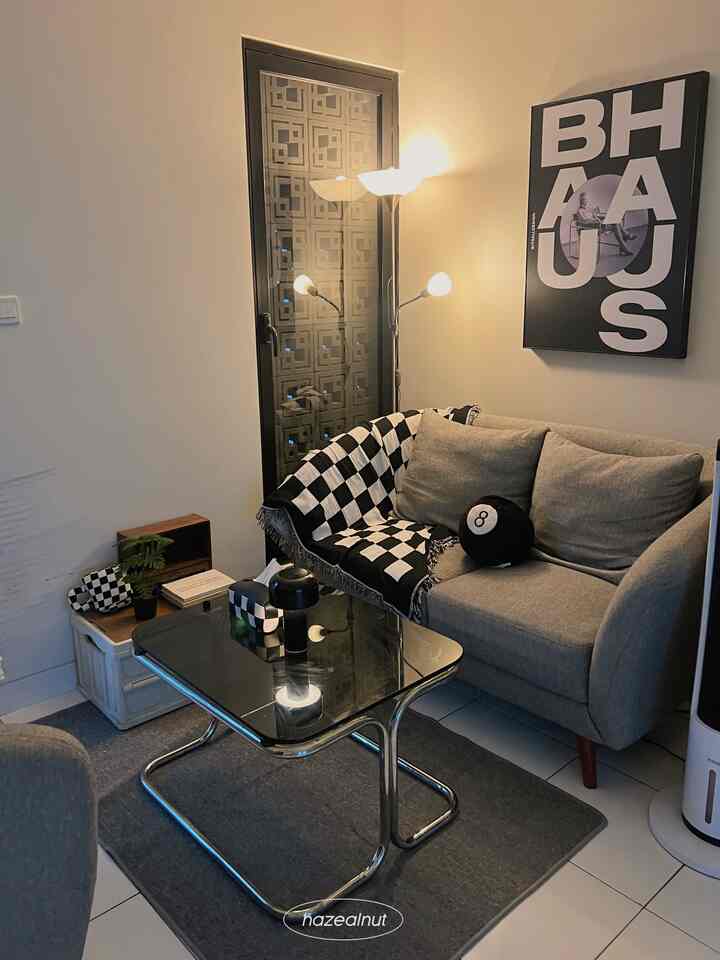 Monotone living room featuring a gray sofa and black coffee table in a clean, modern setup