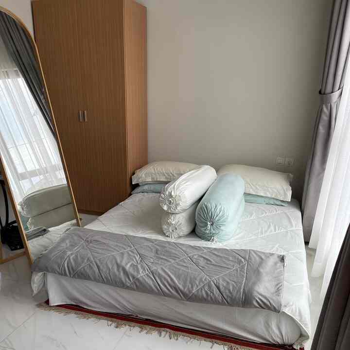 White and brown toned bedroom featuring bed, wardrobe, and full-length mirror with a simple atmosphere