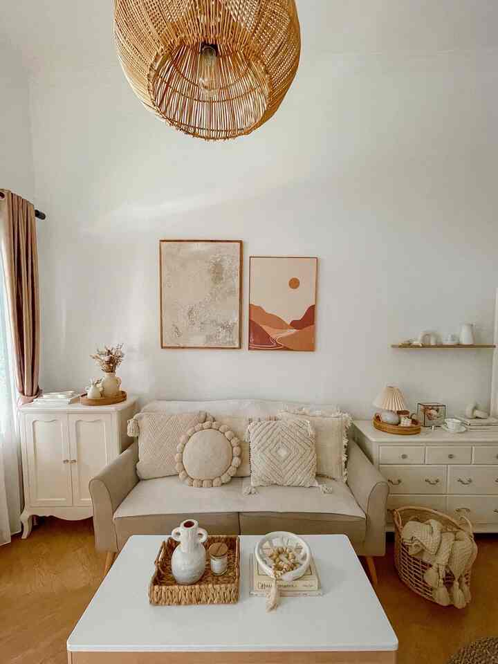 White and wood tone living room featuring beige sofa with cushions and rattan pendant light creating a cozy natural modern atmosphere