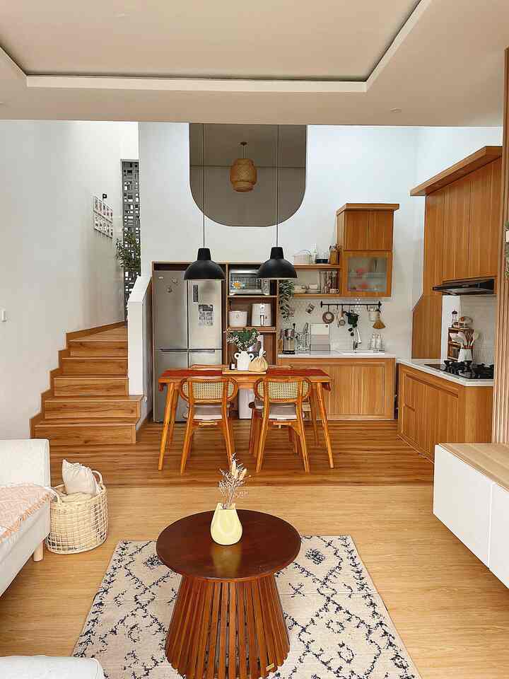 Warm Scandinavian living and kitchen space featuring wood tones and natural colors