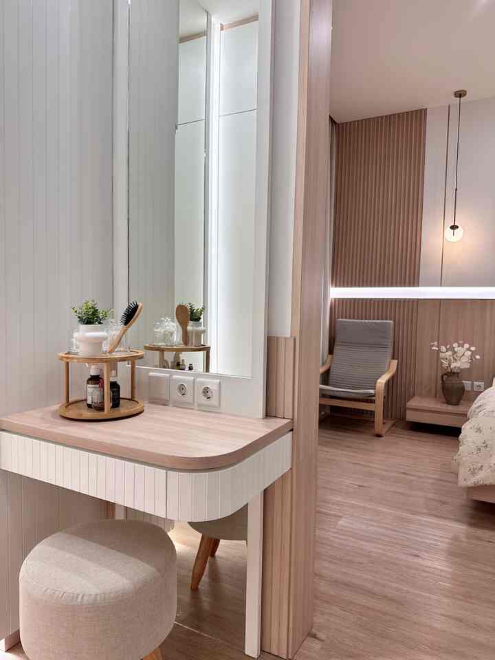 Natural color wood tone bedroom featuring a vanity, armchair, and pendant light with a warm, simple atmosphere