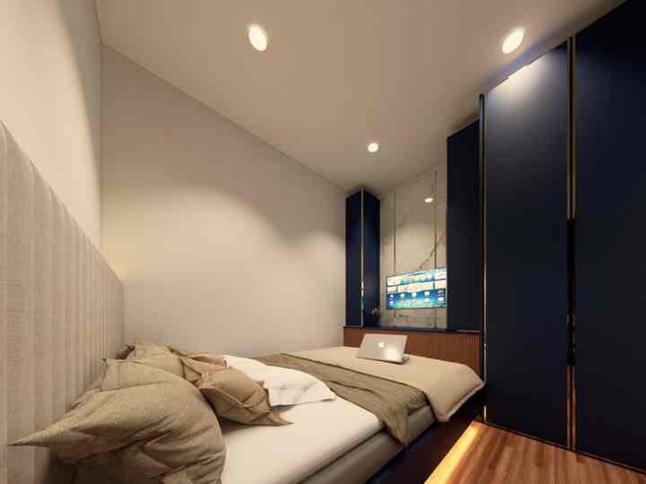 A small modern bedroom in beige and navy tones featuring a bed and large storage cabinets, creating a cozy space