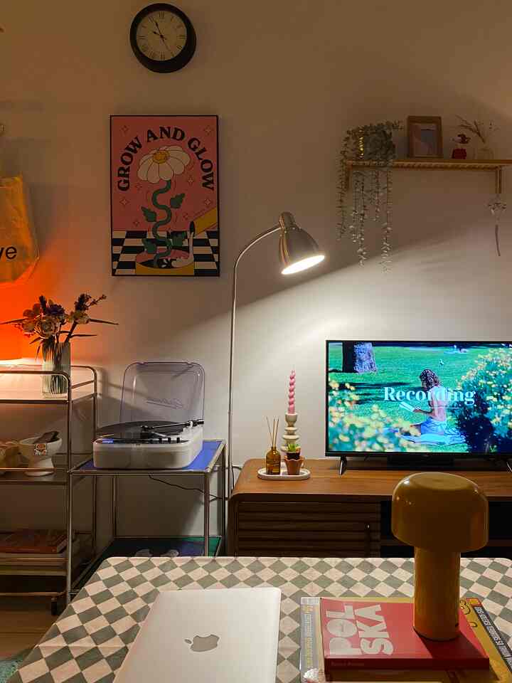 Warm brown and white toned mid-century modern living room featuring vintage turntable and art poster creating cozy ambiance